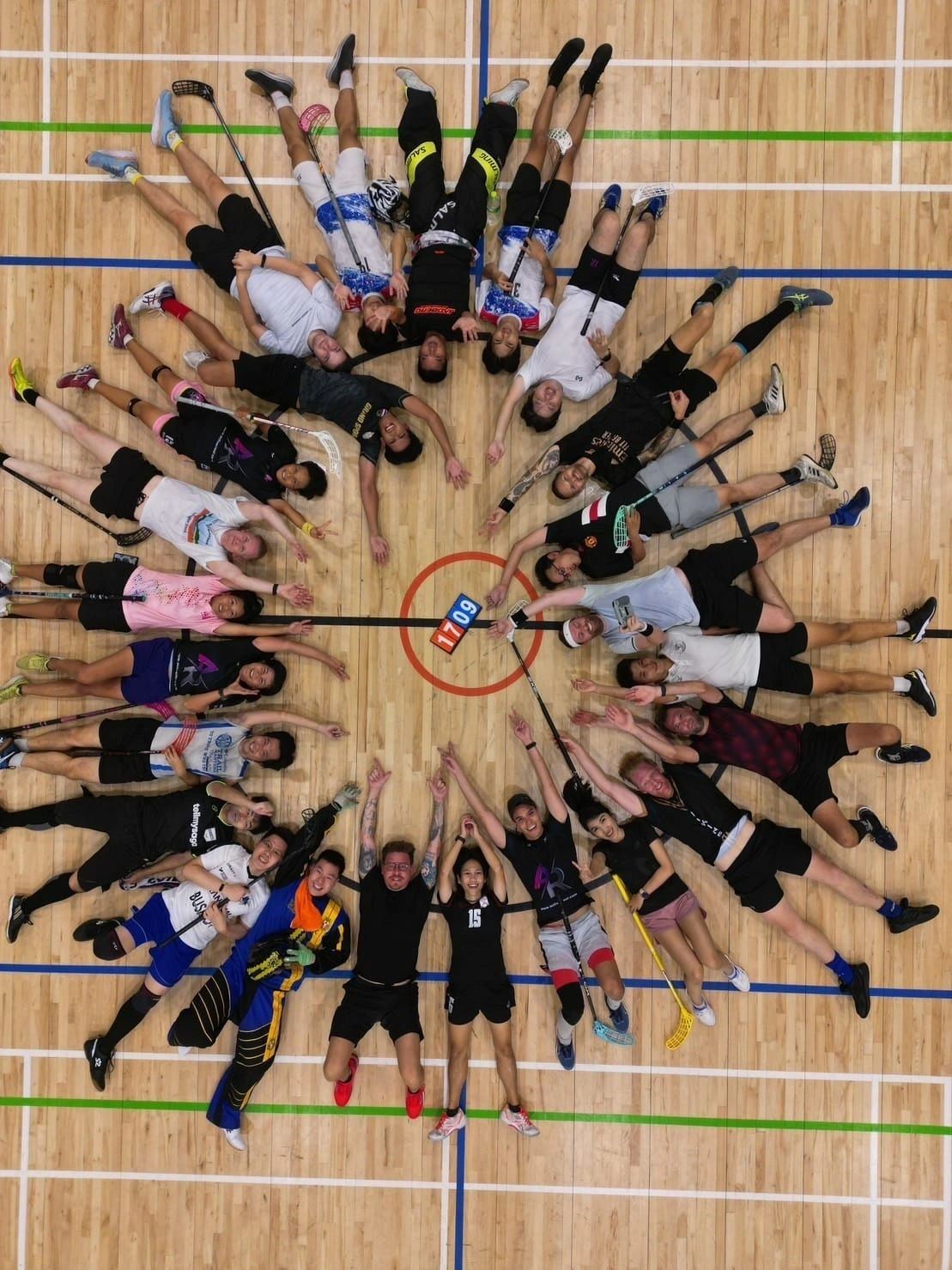 Players lying in a circle on the court after a Sunday session